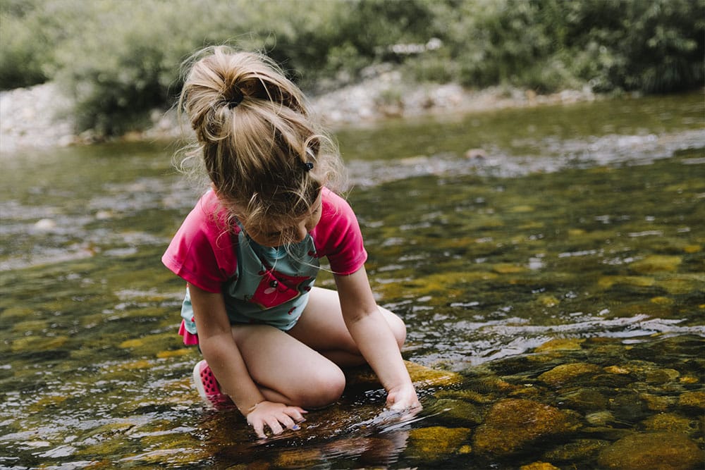 Child exploring water